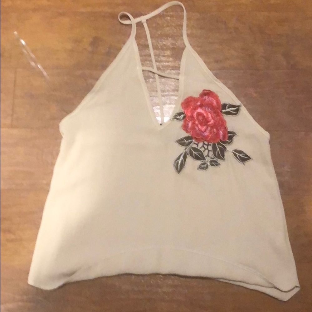 Sleeveless shirt with straps keeping it on.